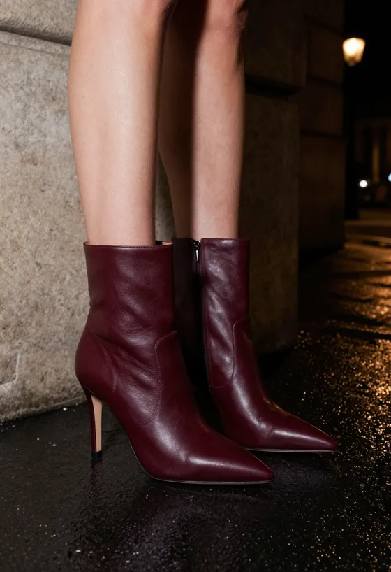 Oxblood Ankle Boot — Pointed, closed, oxblood, photographed at night.